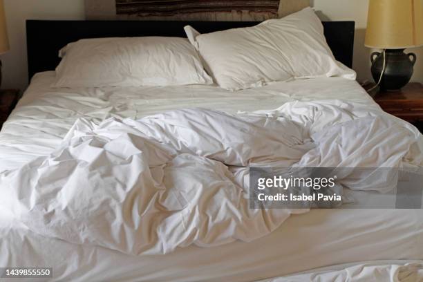 unmade bed at hotel - materasso foto e immagini stock