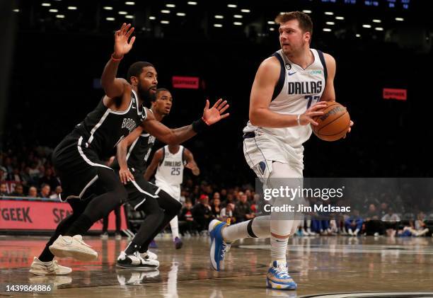 Luka Doncic of the Dallas Mavericks in action against Kyrie Irving of the Brooklyn Nets at Barclays Center on October 27, 2022 in New York City. The...