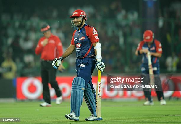 Delhi Daredevils batsman Virender Sehwag walks back to the pavillion after losing his wicket during the IPL Twenty20 cricket match between Delhi...