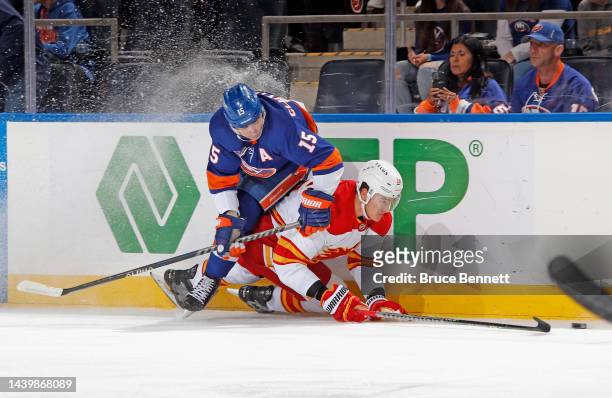 Cal Clutterbuck of the New York Islanders and Nikita Zadorov of the Calgary Flames collide during the first period at the UBS Arena on November 07,...