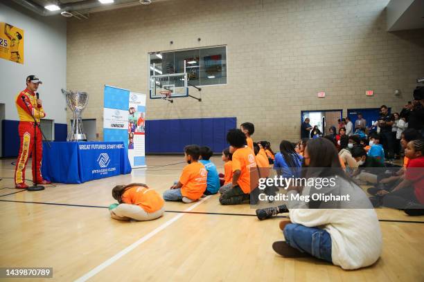 Joey Logano, driver of the Shell Pennzoil Ford, talks with kids at the Boys & Girls Club on November 07, 2022 in Los Angeles, California.