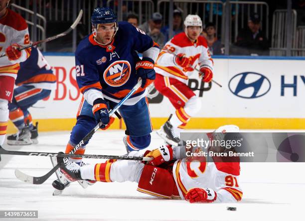 Kyle Palmieri of the New York Islanders checks Nazem Kadri of the Calgary Flames during the first period at the UBS Arena on November 07, 2022 in...