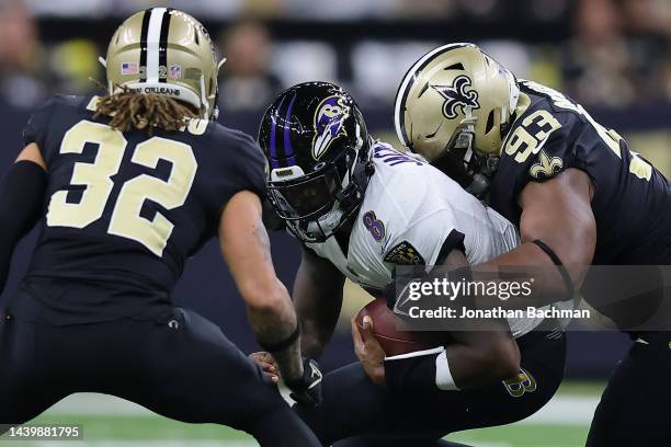 Lamar Jackson of the Baltimore Ravens is sacked by David Onyemata of the New Orleans Saints during the first quarter at Caesars Superdome on November...