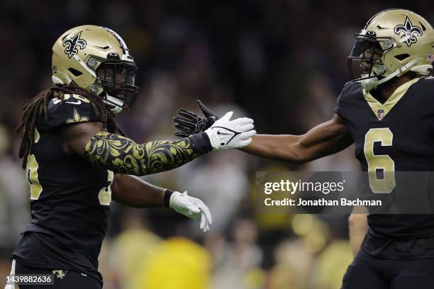 Demario Davis and Marcus Maye of the New Orleans Saints celebrate after a defensive stop during the first quarter against the Baltimore Ravens at...