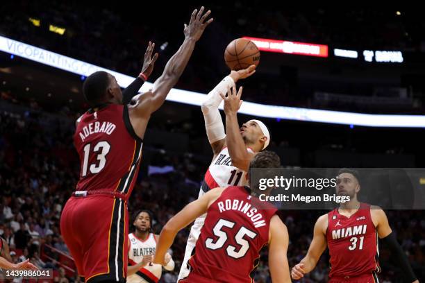 Josh Hart of the Portland Trail Blazers shoots over Bam Adebayo and Duncan Robinson of the Miami Heat during the second quarter of the game at FTX...