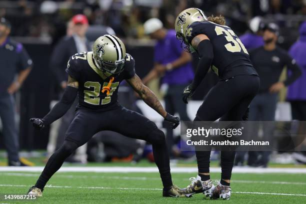 Alontae Taylor of the New Orleans Saints celebrates with Tyrann Mathieu after breaking up a pass during the second quarter against the Baltimore...