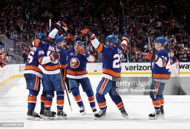 The New York Islanders celebrate a 3-2 overtime victory over the Calgary Flames at the UBS Arena on November 07, 2022 in Elmont, New York.