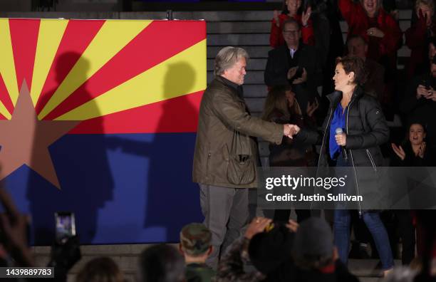 Steve Bannon greets Arizona Republican gubernatorial candidate Kari Lake during a get out the vote campaign rally on November 07, 2022 in Prescott,...