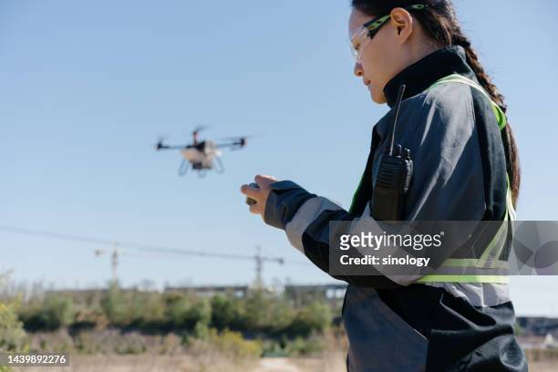farmer is spraying fertilizers with drones - farmer drone stock pictures, royalty-free photos & images