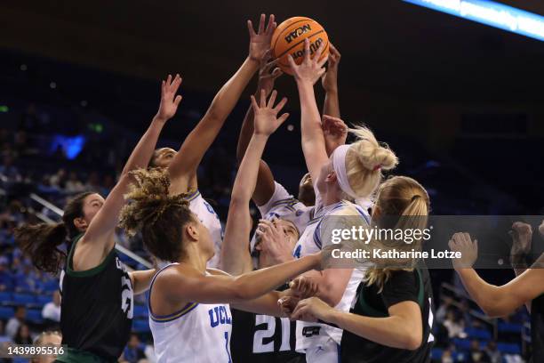 The UCLA Bruins and the Cal Poly Mustangs go up for a rebound during the second half of a game at UCLA Pauley Pavilion on November 07, 2022 in Los...