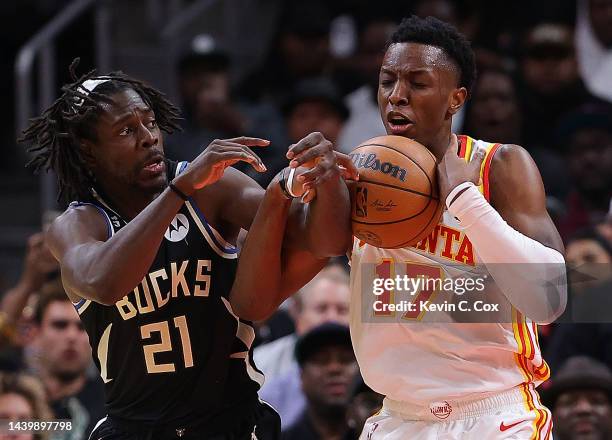 Onyeka Okongwu of the Atlanta Hawks battles for a rebound against Jrue Holiday of the Milwaukee Bucks during the second half at State Farm Arena on...