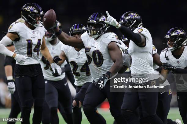 Justin Houston of the Baltimore Ravens celebrates with teammates after an interception during the fourth quarter against the New Orleans Saints at...