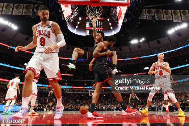 Scottie Barnes of the Toronto Raptors celebrates a dunk on Nikola Vucevic of the Chicago Bulls during the first half at United Center on November 07,...