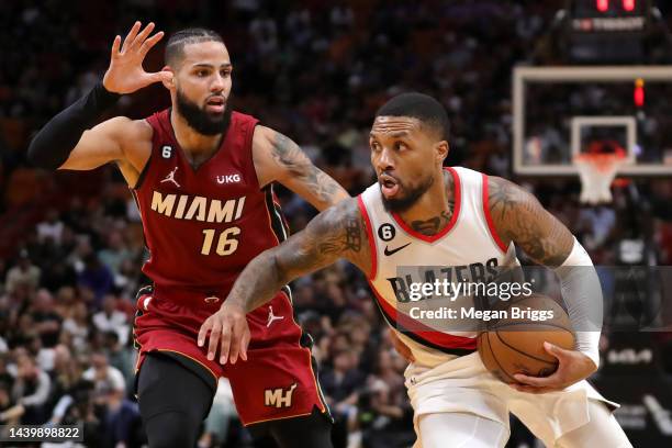 Damian Lillard of the Portland Trail Blazers drives past Caleb Martin of the Miami Heat during the second quarter at FTX Arena on November 07, 2022...