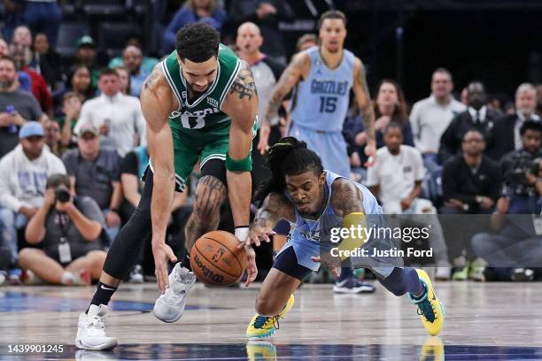 Ja Morant of the Memphis Grizzlies and Jayson Tatum of the Boston Celtics go after a loose ball during the second half of the game at FedExForum on...