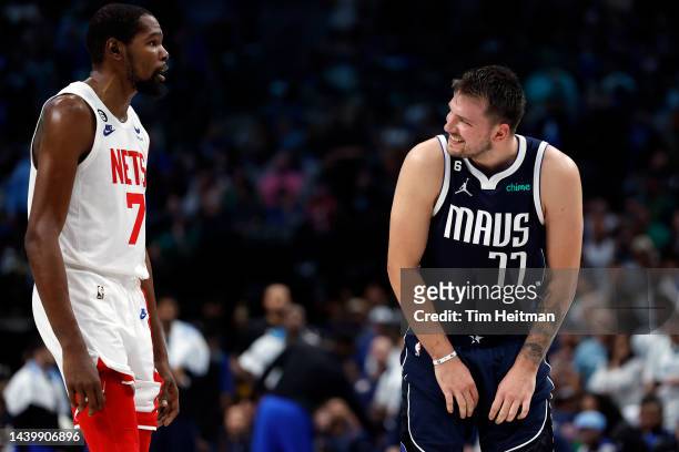 Luka Doncic of the Dallas Mavericks smiles at Kevin Durant of the Brooklyn Nets during the second half of the game at American Airlines Center on...