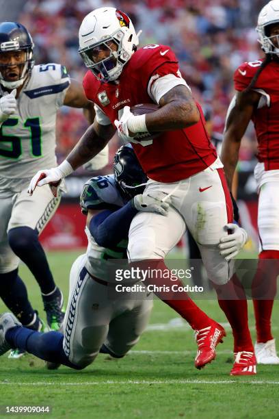 Running back James Conner of the Arizona Cardinals runs while being tackled by linebacker Jordyn Brooks of the Seattle Seahawks during the second...