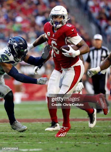 Running back James Conner of the Arizona Cardinals stiff arms linebacker Jordyn Brooks of the Seattle Seahawks during the second half at State Farm...