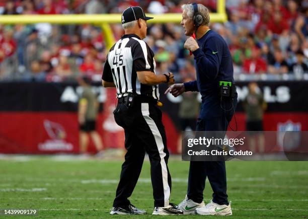 Head coach Pete Carroll of the Seattle Seahawks talks to line judge Jeff Seeman during the second half against the Arizona Cardinals at State Farm...
