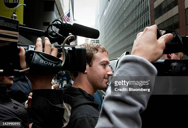 Mark Zuckerberg, founder and chief executive officer of Facebook Inc., center, leaves the Sheraton hotel in New York, U.S., on Monday, May 7, 2012....