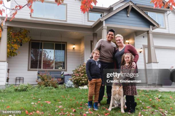 diverse family portraits in front of home - homeownership month stock pictures, royalty-free photos & images