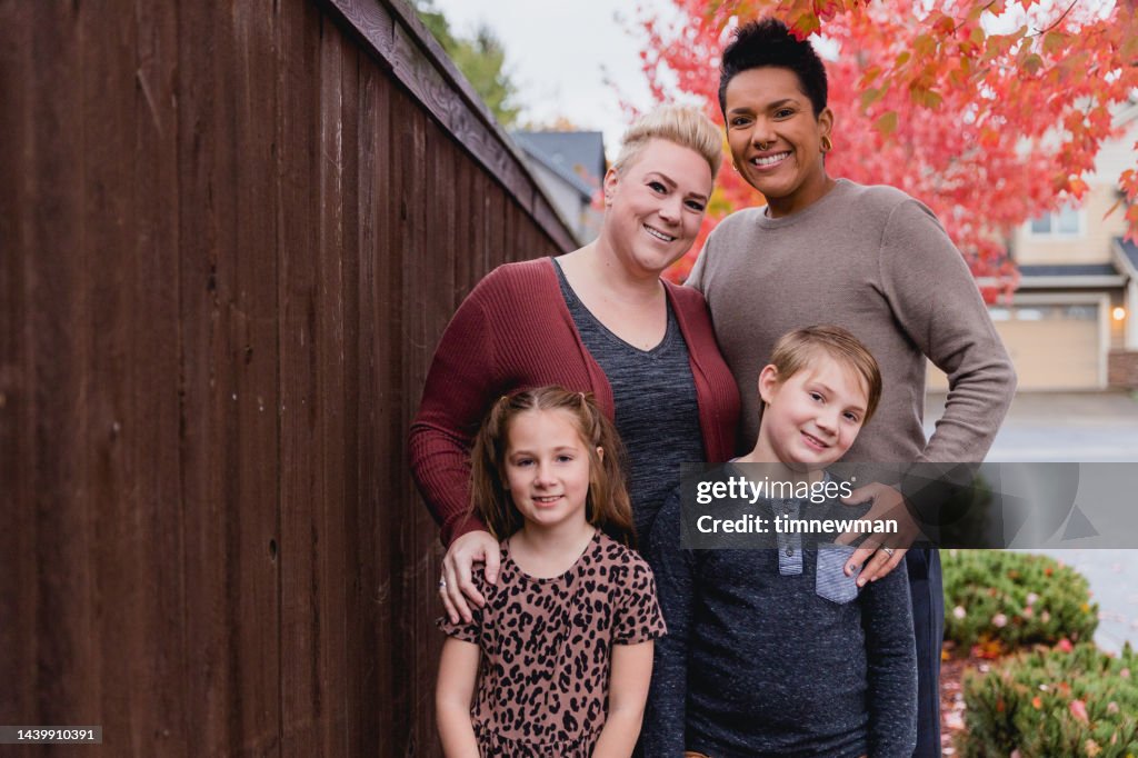 Diverse Family Portraits In Front of Home