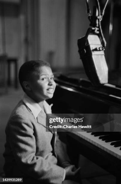 American pianist and singer Sugar Chile Robinson performing with musicians at Lime Grove Studios in London, England, August 1951. Original...