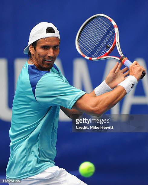 Juan Ignacio Chela of Argentina plays a backhand during his defeat to qualifier Alejandro Falla of Colombia in the Mutua Madrilena Madrid Open at the...
