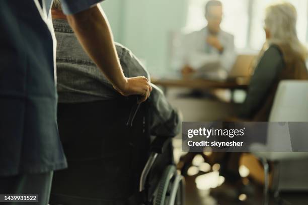 assisting disabled patient in hospital! - pushing stock pictures, royalty-free photos & images