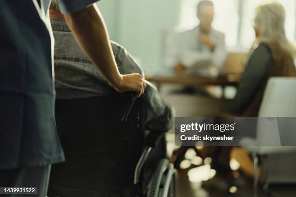 assisting disabled patient in hospital! - entering hospital stock pictures, royalty-free photos & images