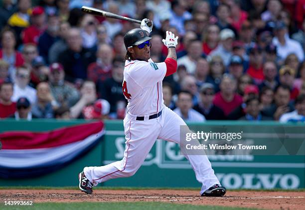 Boston Red Sox's Darnell McDonald follows through on a hit against the Tampa Bay Rays during the Opening Day game on Friday, April 13, 2012 at Fenway...