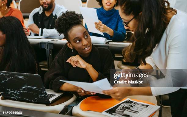 female student and teacher discussing over test result in class - university professor stock pictures, royalty-free photos & images