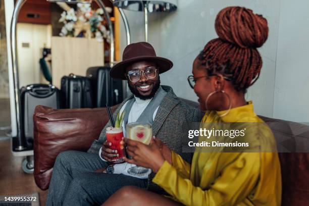 happy african american couple toasting with cocktails. - luggage trolley stock pictures, royalty-free photos & images