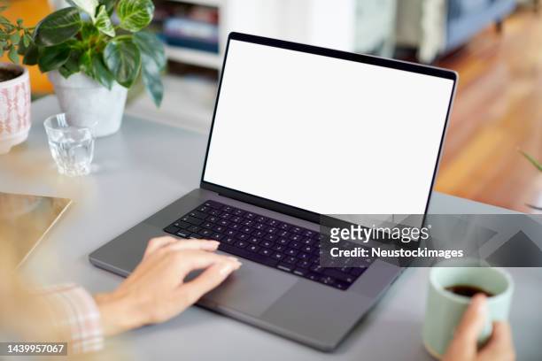 businesswoman working on laptop with blank screen - blank screen stock pictures, royalty-free photos & images