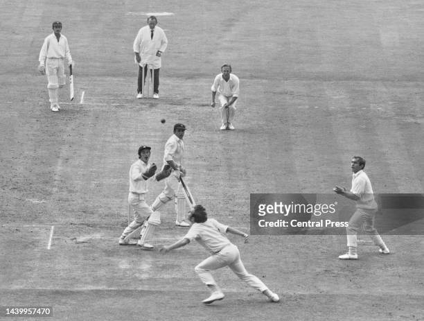 England Wicketkeeper Alan Knott and slip fielder John Edrich look on from behind the stumps as Richard Hutton of England moves to catch batsman Ashok...