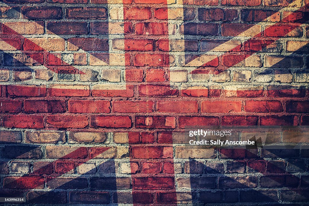 Union Jack flag on brick wall