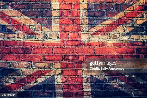 union jack flag on  brick wall - union jack stock pictures, royalty-free photos & images