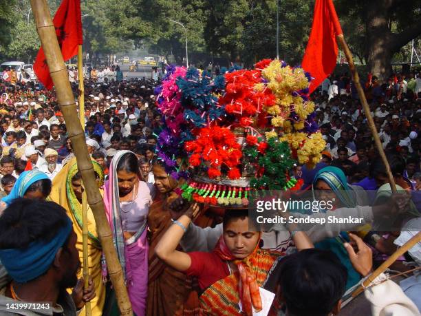 Colourfully dressed crowds celebrate the passage of the draft Tribal Rights Bill during a rally in New Delhi.