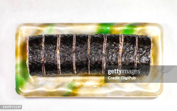 futomaki in disposable plastic tray - nori stock pictures, royalty-free photos & images