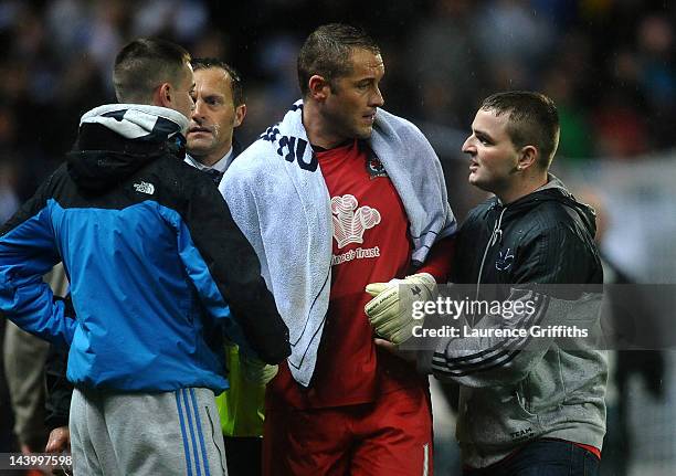 Paul Robinson of Blackburn Rovers is consoled by fans on the pitch at the end of the Barclays Premier League match between Blackburn Rovers and Wigan...