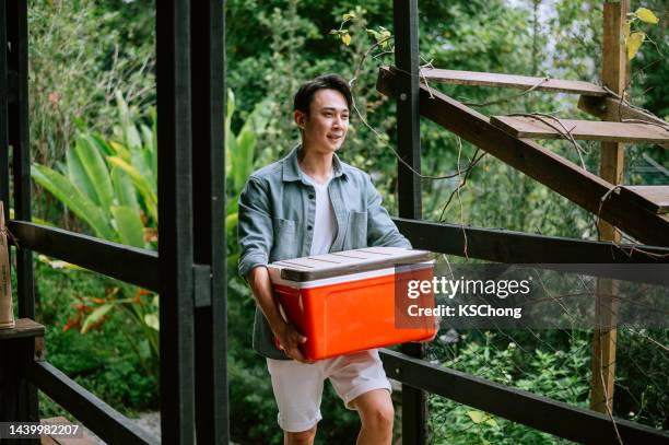 asian young man  preparation for journey in summer time - champagne bucket stock pictures, royalty-free photos & images