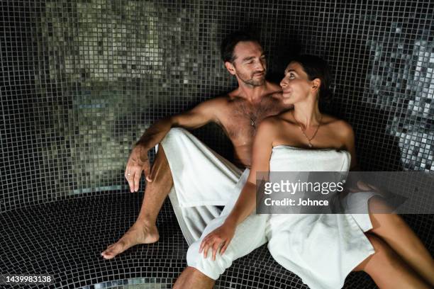 couple enjoying luxury spa moments - sauna wellness stock pictures, royalty-free photos & images