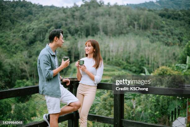 an asian chinese couple having great time - asian coffee at cafe imagens e fotografias de stock