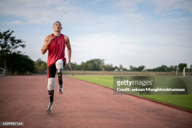 disabled man athlete training with leg prosthesis. - paralympics track stock pictures, royalty-free photos & images
