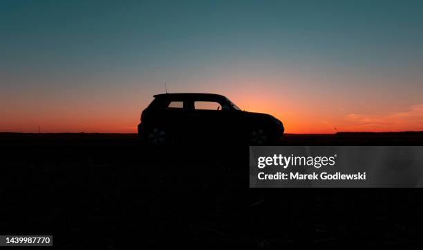 silhouette of a car at sunset, - car road sunset fotografías e imágenes de stock