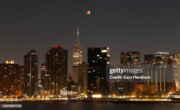 The blood-red full Beaver Moon passes over the Empire State Building during a total lunar eclipse on November 8 in New York City.