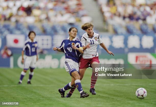 Olga Letyushova, Forward for Russia challenges Homare Sawa, Captain and Midfielder for Japan during their Group C match of the FIFA Women's World Cup...