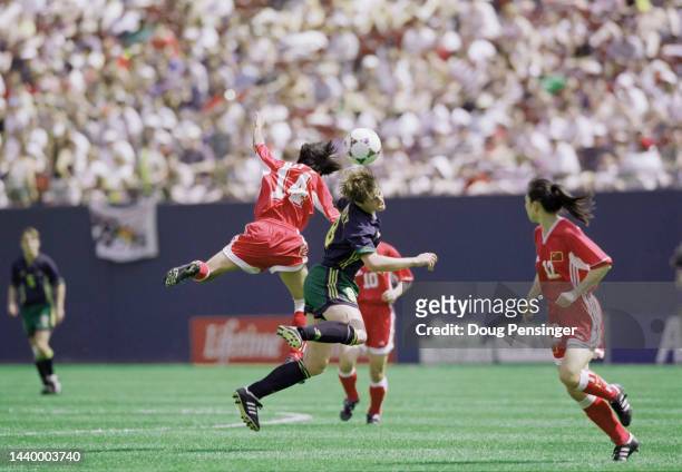 Bai Jie, Midfield for China and Cheryl Salisbury, defender for Australia challenge for the ball in mid air during their Group D match of the FIFA...