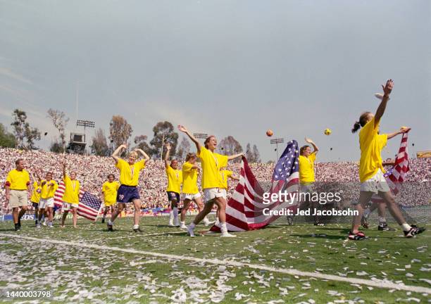 The United States Women's Soccer team carry the Stars and Stripes flag in celebration after winning the Final match of the FIFA Women's World Cup...