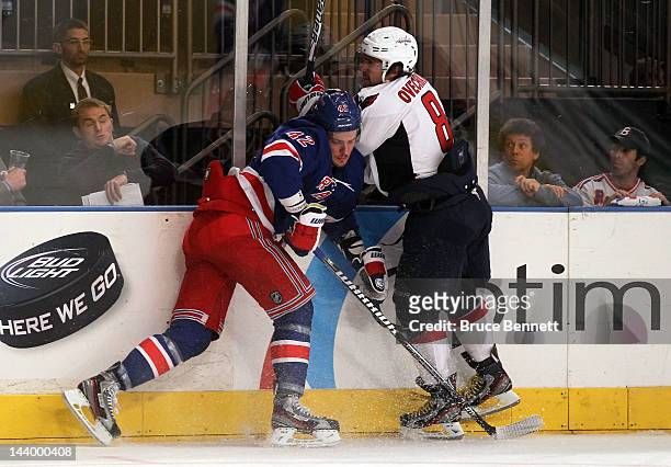 Artem Anisimov of the New York Rangers checks Alex Ovechkin of the Washington Capitals in Game Five of the Eastern Conference Semifinals during the...